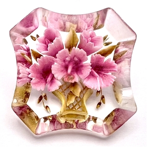 Reverse carved acrylic button of bouquet of pink flowers.