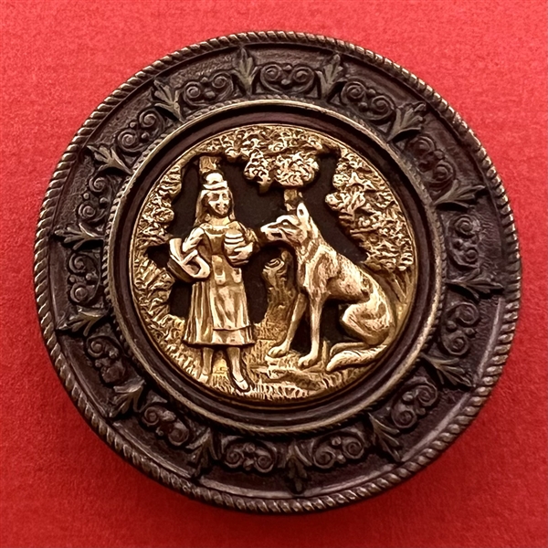 Heavily tinted “Red Riding Hood and the Wolf” brass with tinted border button,