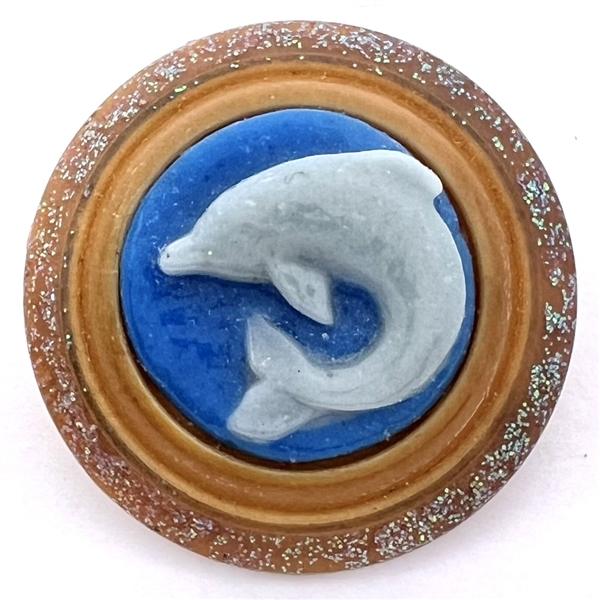 Glass dolphin set in vegetable ivory button by Bob Benson