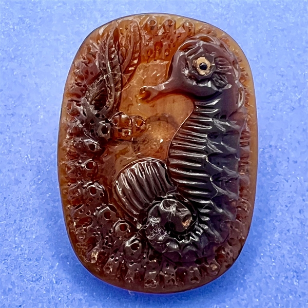 Seahorse button of carved horn (?). 