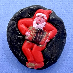 Resin button of man dressed as Santa playing an accordion.