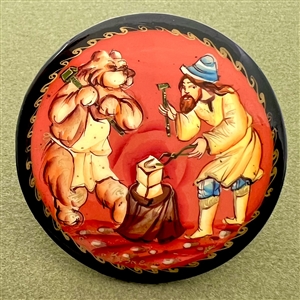 Russian lacquer button of man and bear doing blacksmithing.