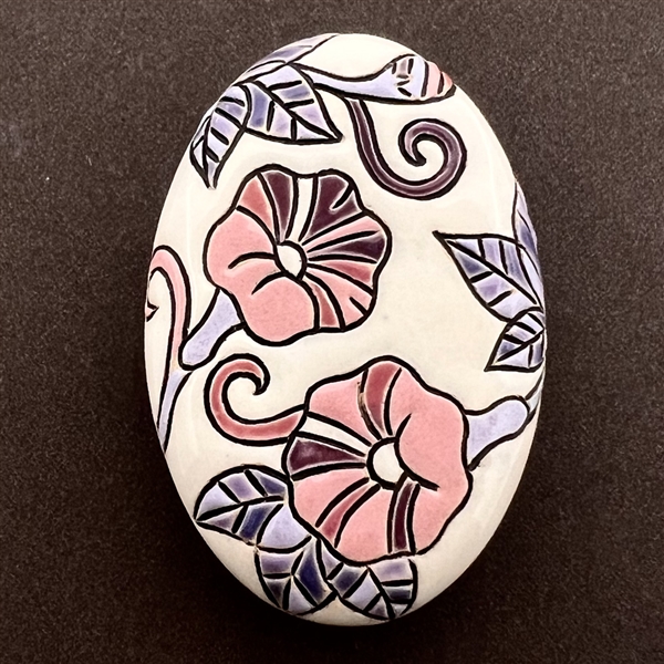 Oval ceramic button of morning glories by the Golem Studio.