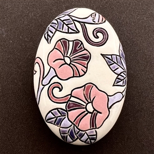 Oval ceramic button of morning glories by the Golem Studio.