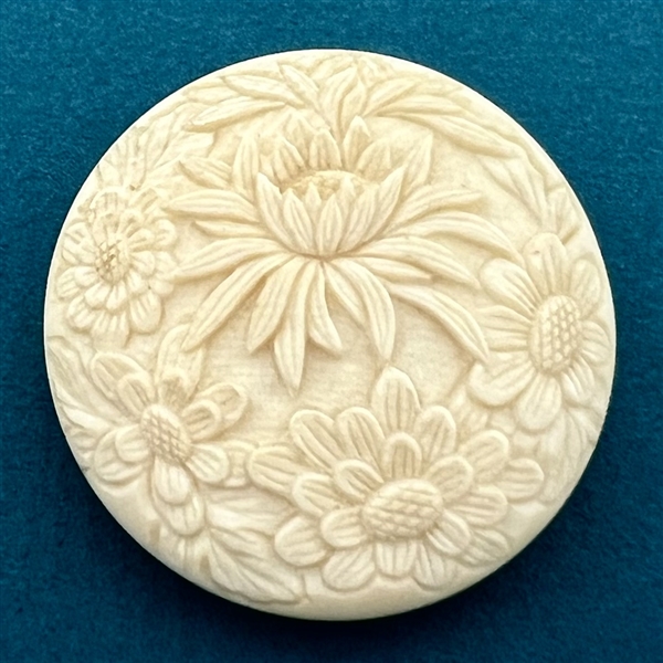 Chrysanthemum and other flowers carved natural material button.