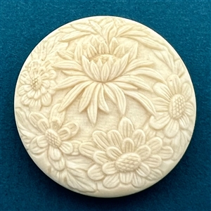 Chrysanthemum and other flowers carved natural material button.