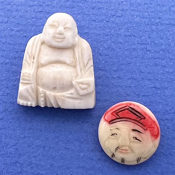 Two Asian theme buttons of natural material.