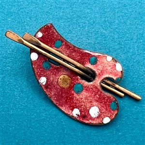 Copper enamel button of realistic artist’s pallet.