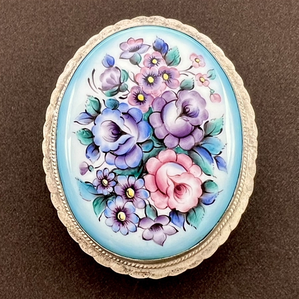 Extra large ceramic button of flowers set in metal.