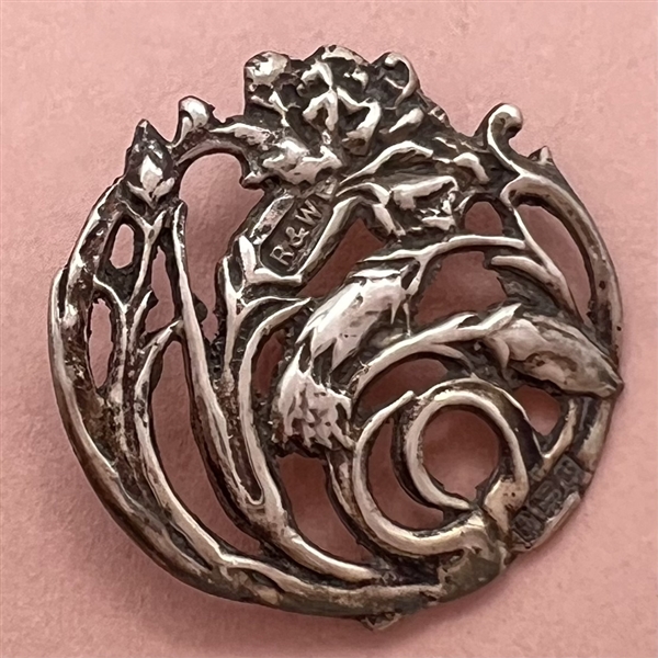 Hallmarked openwork silver button of a plant (thistle?).