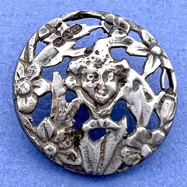 Hallmarked openwork silver button of a fairy face in garden.