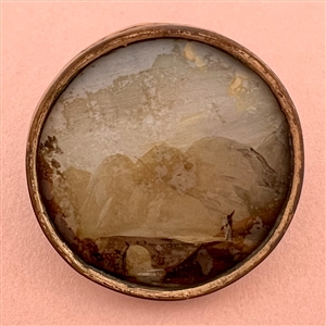  An 18th c. detailed painting under glass of traveler on bridge button.