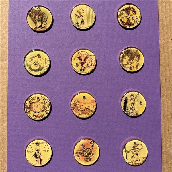 Set of twelve zodiac studio buttons by Cynthia Tsubaki.