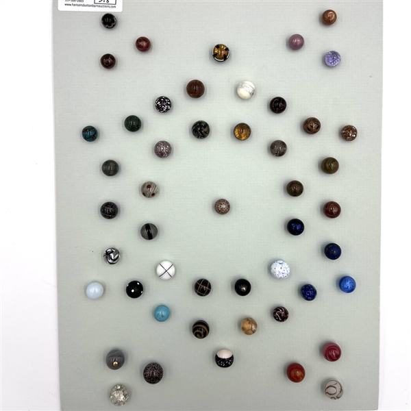 Card of forty three glass ball buttons.