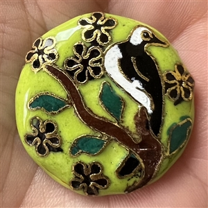 Chinese cloisonné button of a bird in a flowering tree.