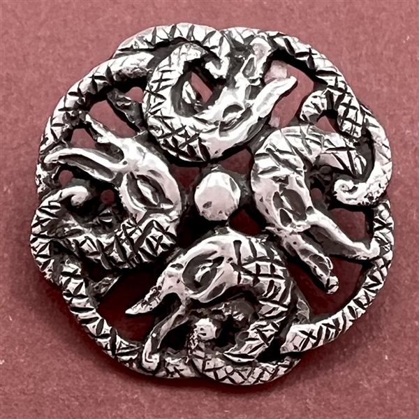 Hallmarked silver button with four snakes.