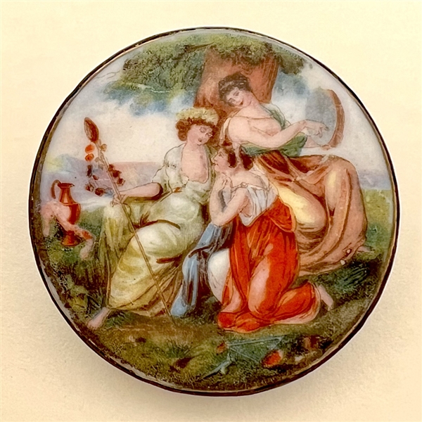 Porcelain button of women gossiping under a tree.