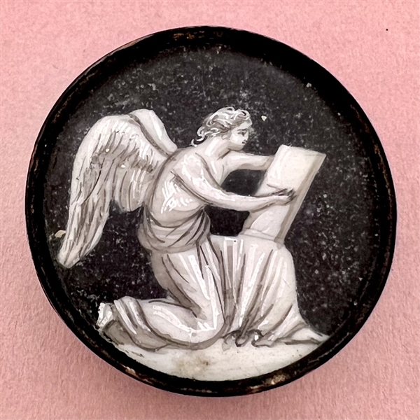 An 18th c. “en grisaille” painting  on natural material button of an angel writing a list.