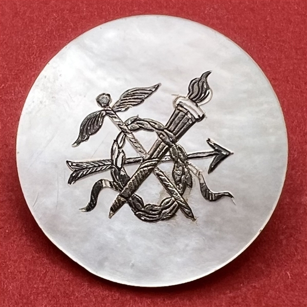 An 18th c. Pearl button of symbols of war.