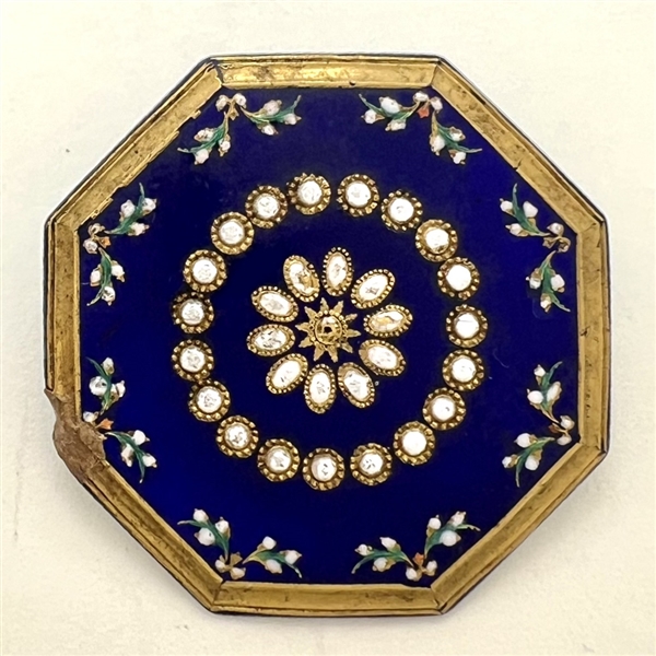 An octagonal cobalt blue enamel button.