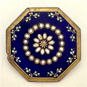 An octagonal cobalt blue enamel button.