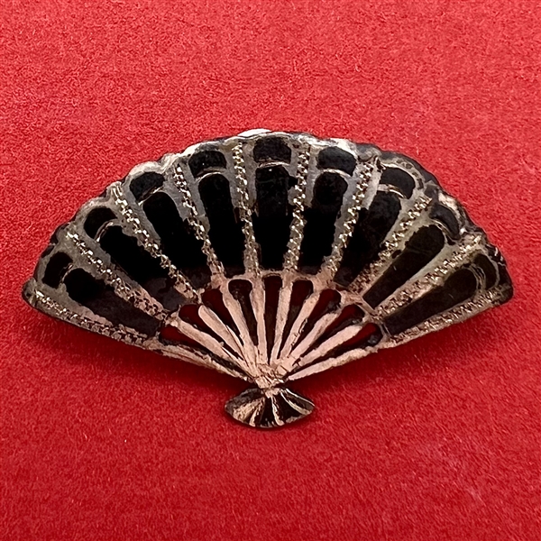 Niello silver button of a realistic fan.