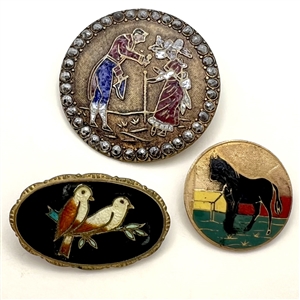 Three enamel buttons of assorted subjects.