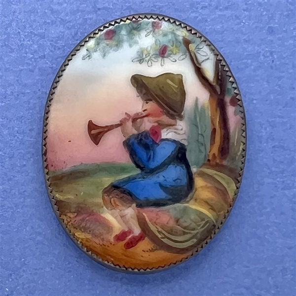 Ceramic oval button of a little boy blue.