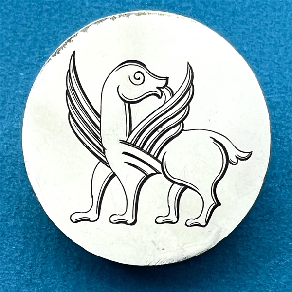 Fabulous creature on metal button.