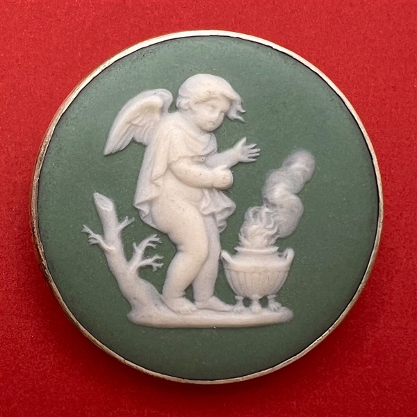 Extra large Wedgwood button of a cherub in front of a brazier.