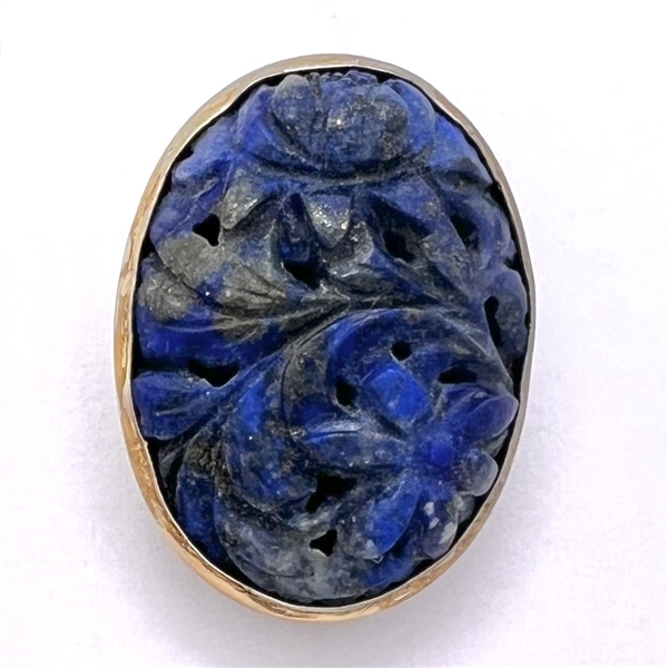 Carved blue jade button of plant life.