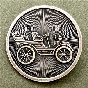 Silvered brass button of early automobile.