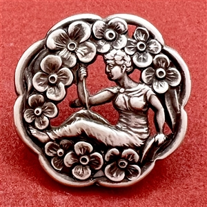 Hallmarked silver button of woman among flowers.