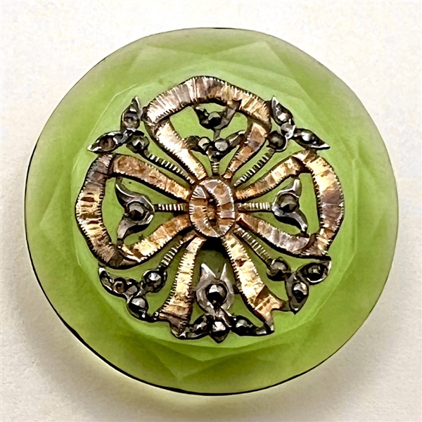 Transparent green glass button with bow.