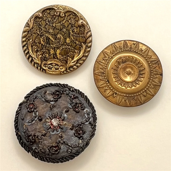 Two 18th c. buttons and a 19th c. button.