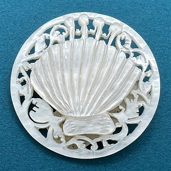 Bethlehem pearl #16 “Scalloped Shell” button.