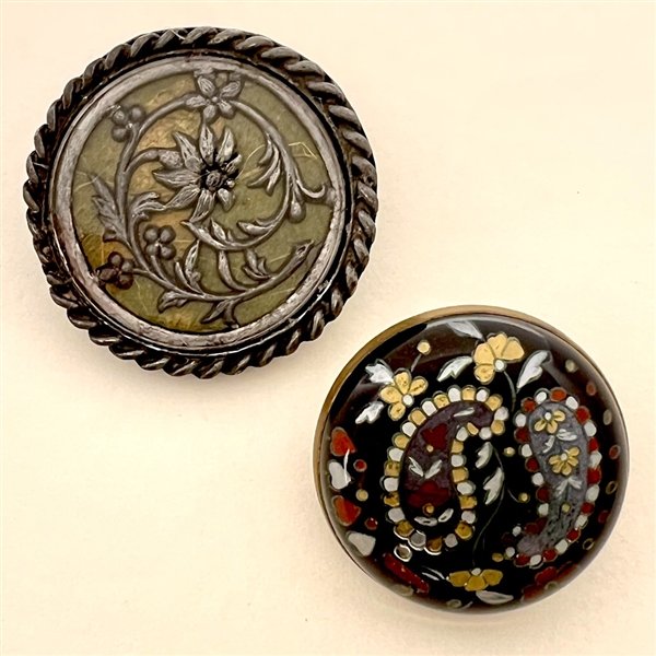 Two design under glass buttons.