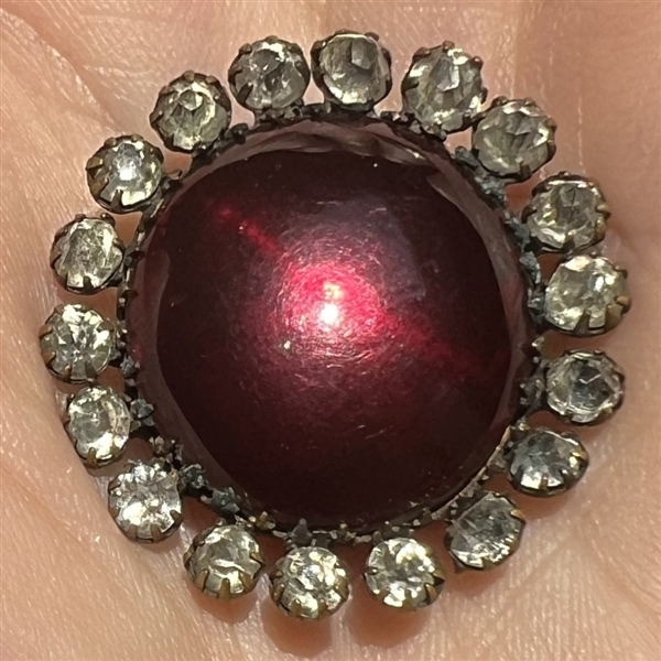 A 19th c. Ruby glass set in metal button.