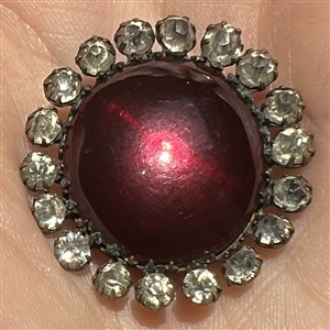 A 19th c. Ruby glass set in metal button.