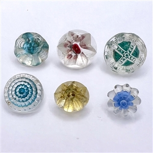 Six old glass radiant buttons.