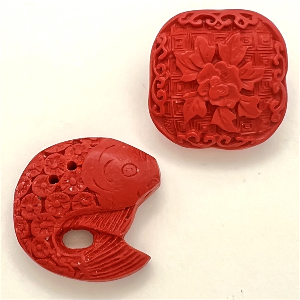 Two modern cinnabar buttons.