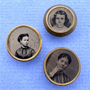 Three tintype buttons of women and a girl.