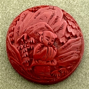 Chinese Cinnabar button of an Asian man in a garden.