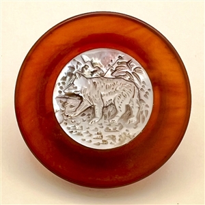 Unusual Bakelite button with carved pearl center of a bear.