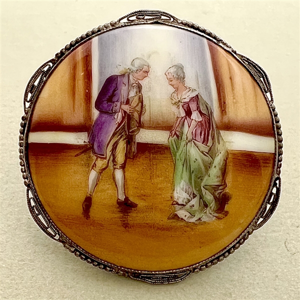 Porcelain ceramic button of man and woman preparing to dance.