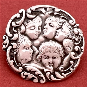 Hallmarked silver button of five cherub heads.