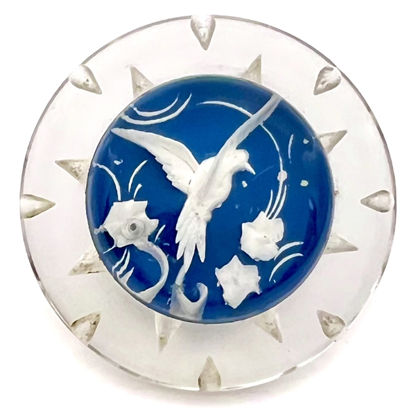 Reverse carved and painted acrylic button of a flying bird.