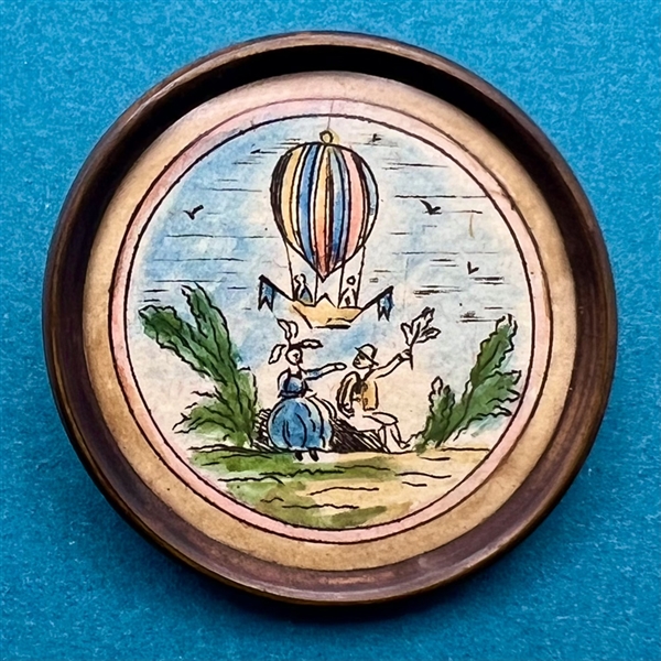 An18th c. hot air balloon - ink and paint on paper under glass button.