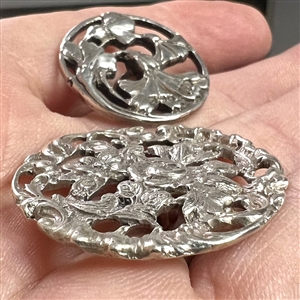 Two hallmarked silver buttons of flowers and leaves.