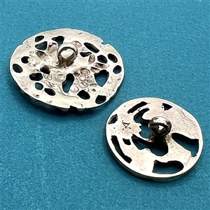 Two hallmarked silver buttons of flowers and leaves.